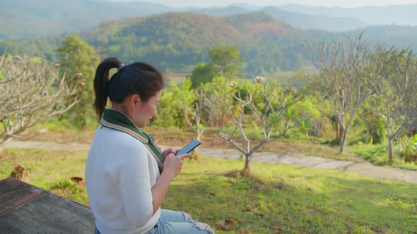 happiness asian female woman hand use smartphone to texting