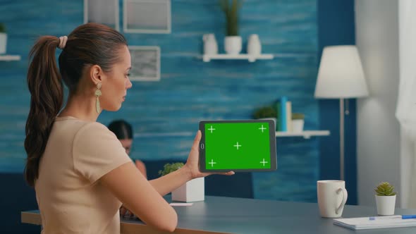 Woman Looking at Tablet Computer with Mock Up Green Screen