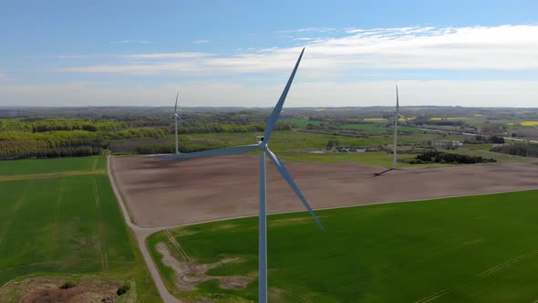 Drone flying towards spinning windmills