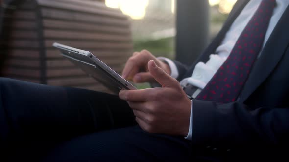 Successful Businessman in Suit Sits Outside in Park and Use Tablet Writes with Finger Transfers