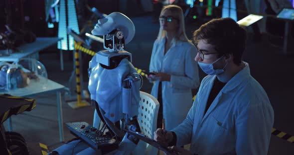 Laboratory Assistants Conduct Research on Humanoid
