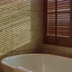 white bathtub in clean bathroom with big window and wooden blindshade with light evening time - VideoHive Item for Sale