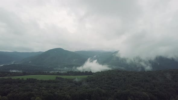 Drone flying up over forest and trees in the Smoky Mountains, USA into the cloudy sky for an incredi