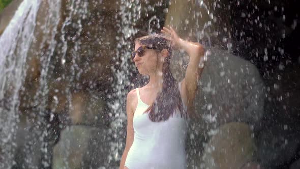 A Young Woman in a Tropical Resort with Hot Springs, Waterfalls and Swimming Pools with Hot Mineral