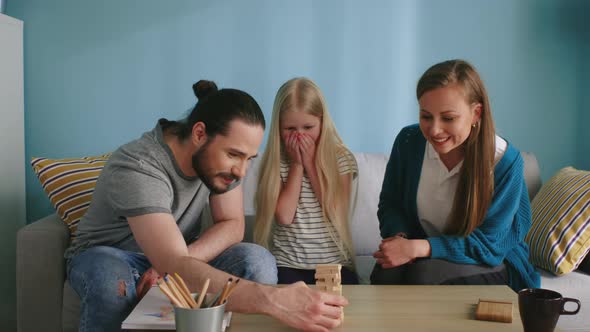 Young Family Plays Jenga at Home