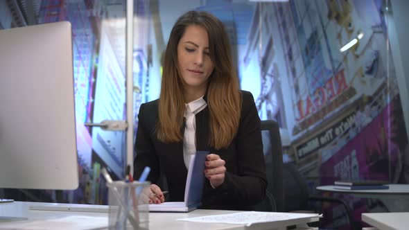 Businesswoman writing at his desk