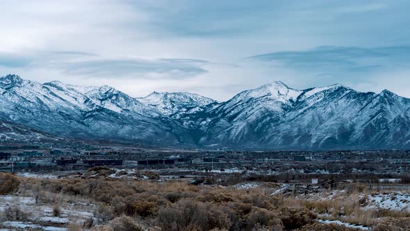 Wasatch Mountain Range, Lehi, Utah and Silicon Slopes on a cold winter day - cloudscape time lapse;