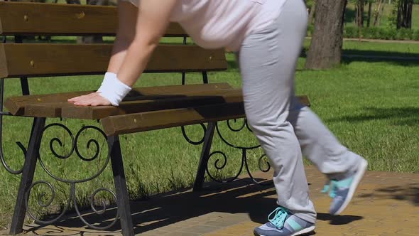 Sweating Fat Lady Resting and Restoring Breath After Exhausted Workout in Park