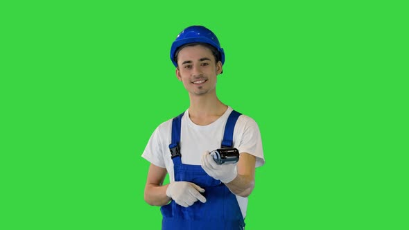 Builder Holding Bank Payment Terminal on a Green Screen Chroma Key