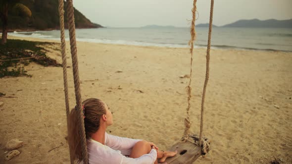 Woman on the Swing on Tropical Beach