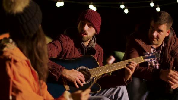 Friends Engjoying a Guitar Solo From One Their Friends