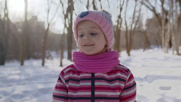 Smiling Child Kid Girl Tourist Walking Having Fun on Snowy Road in Winter Sunny Park Forest Sunset