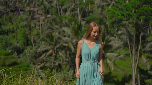 Slowmotion Shot of a Beautiful Young Woman in a Blue Dress Visits Famous Tegalalang Rice Terraces in