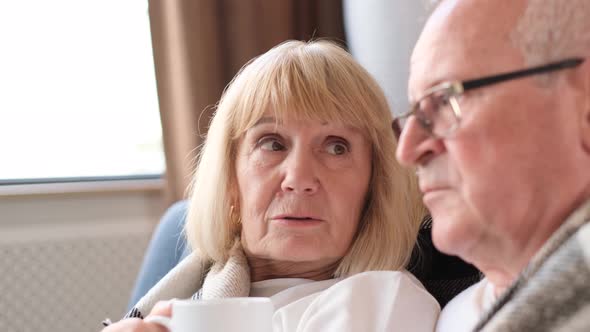 Happy Retired Couple Drinking Tea and Spending Time Together