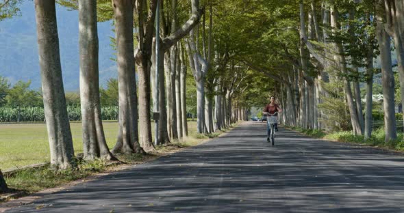 Woman ride a bike in countryside