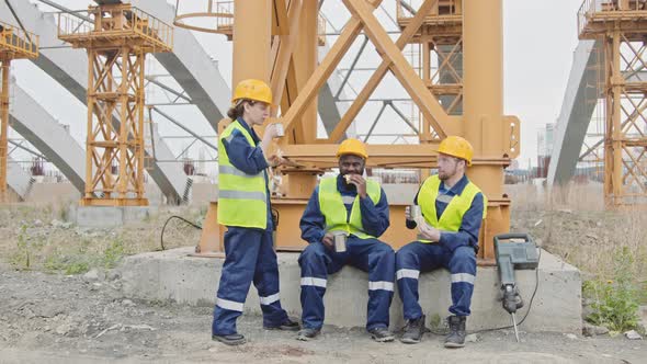 Three Construction Workers Having Lunch Break