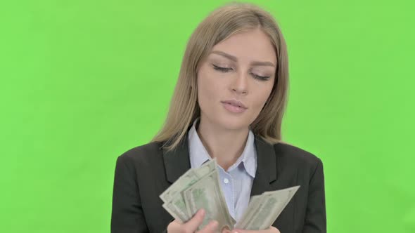 Beautiful Businesswoman Counting Money Against Chroma Key