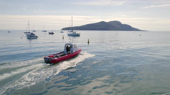 A Small Passenger Ferry Heading Towards an Island in the Summer