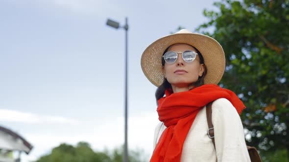 Serious girl with a red scarf outdoors