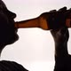 The Silhouette of Male head drinking from a brown bottle - VideoHive Item for Sale
