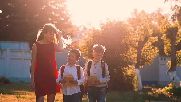 Lady Walks with Children Throwing Books After Exams