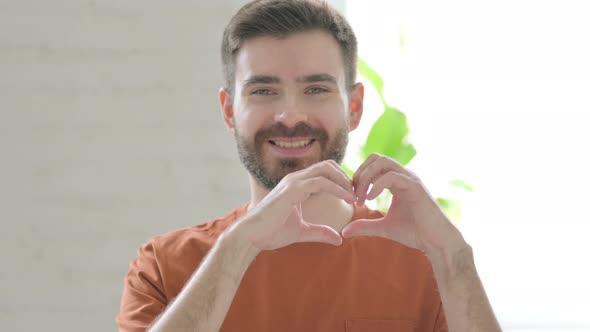 Young Man Showing Heart Shape By Hands