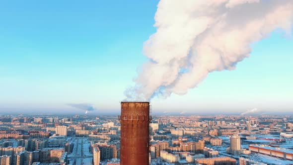 Aerial View of Smoking Chimneys in a Residential Area of the City at Sunset in Winter