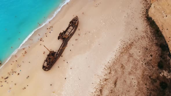 Aerial drone view of the Navagio beach on the Ionian Sea coast of Zakynthos, Greece. Moored boat