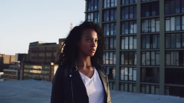 Fashionable young woman on urban rooftop