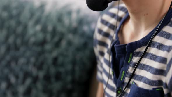 Boy with Gamepad Playing Video Game at Home