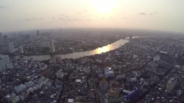 Aerial shot passing over the Bangkok City evening by drone