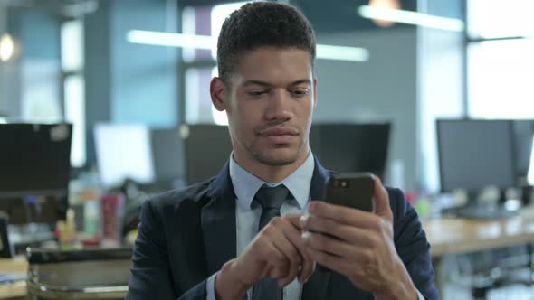 Portrait of African Businessman Using Smartphone