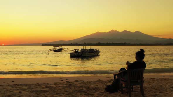 Samar Island, Philippines - Tourist Woman Sitting On the Wooden Chair On the Beach While Watching Th