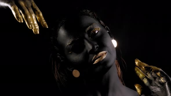 Art Portrait of a Young Female Model with Black Skin Golden Lips Hands Eyes