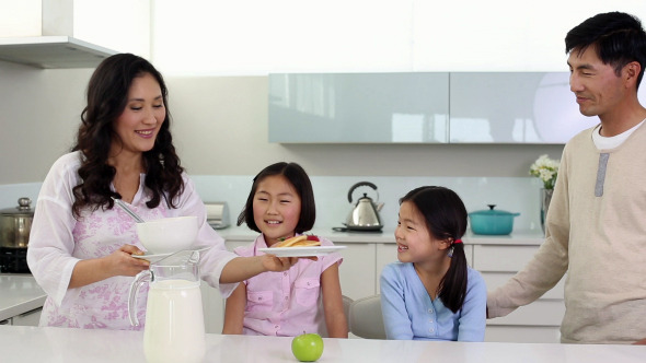 Parents Serving Breakfast To Their Cute Daughters