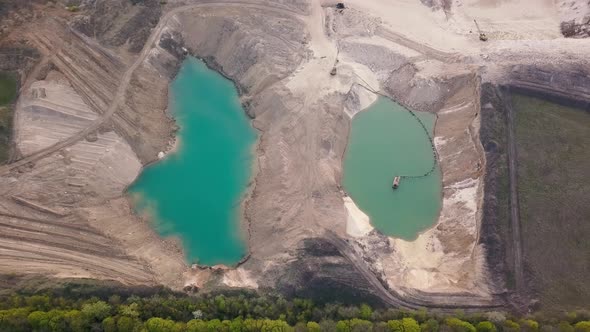 Aerial view of a sand quarry full with green water