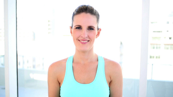 Smiling Fit Woman Showing Two Apples