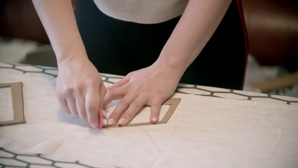 Young Woman Seamstress Making Marks Using the Soap and Form Indoors