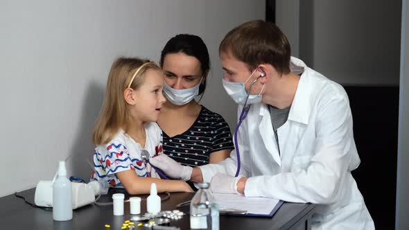 Doctor Examining Toddler Girl By Stethoscope