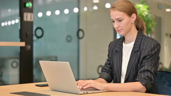 Professional Businesswoman Working on Laptop in Office 