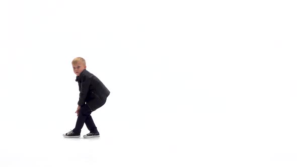 Little Boy Is Dancing a Modern Dance on the White Background in Black Leather Jackets and Jeans