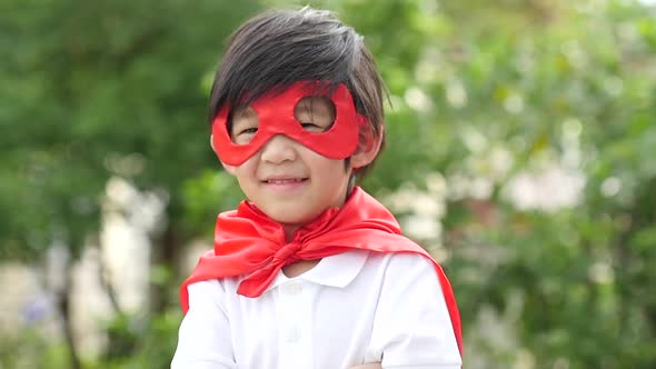 Asian Child In In Superhero Costume Playing In The Park Slow Motion