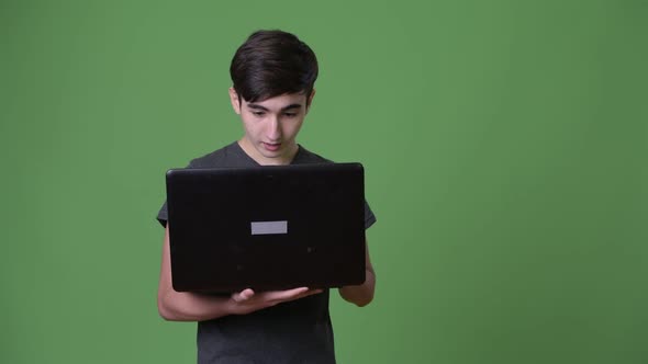 Young Handsome Iranian Teenage Boy Against Green Background