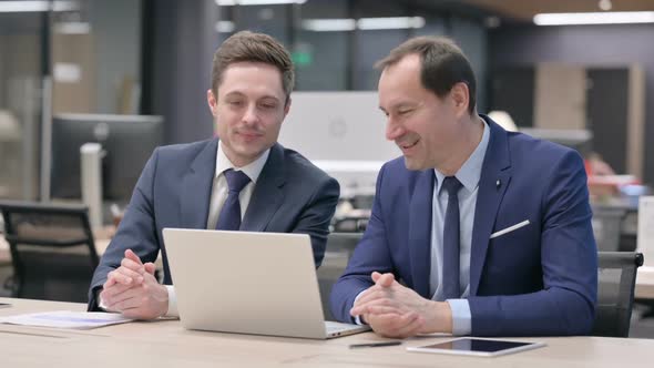 Businessman and Colleague Doing Video Call on Laptop