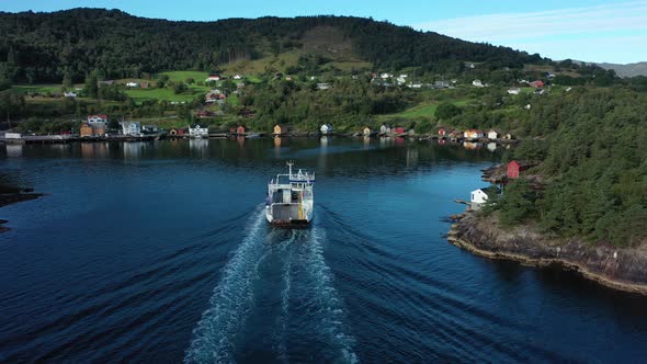 Electric ferry Ytteroyningen soon to arrive at Utbjoa ferry pier Norway - Aerial crossing behind ves