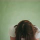 Despaired Woman Shakes Blonde Hair Clutching Head on Green - VideoHive Item for Sale