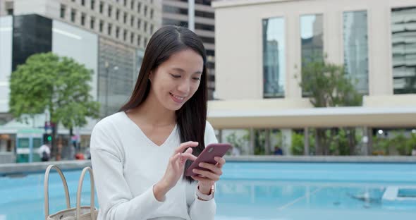 Woman look at mobile phone in Hong Kong