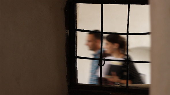 People Passing Iron Window