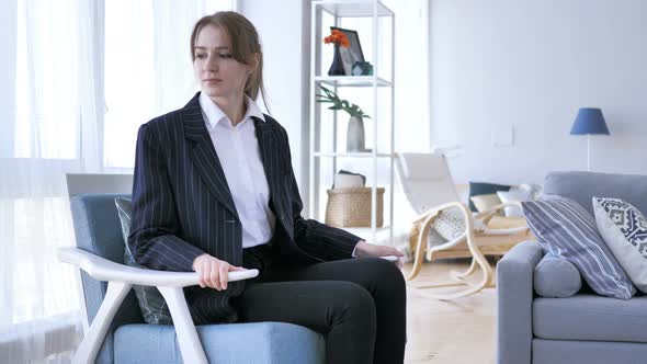 Young Woman Coming To Room and Sitting on Sofa