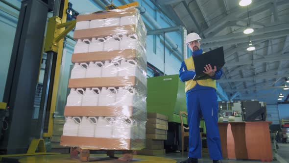 Automatic Packaging of Plastic Canisters Under Male Engineer's Supervision